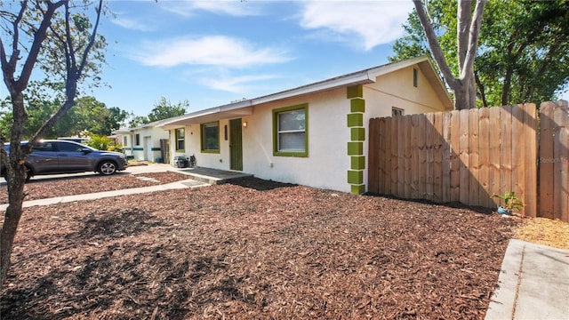 6325 9th Ave S, Gulfport, FL 33707 - ranch-style house with stucco siding and fence