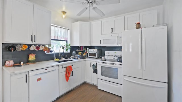 6325 9th Ave S, Gulfport, FL 33707 - kitchen with white appliances, a sink, white cabinetry, and light countertops