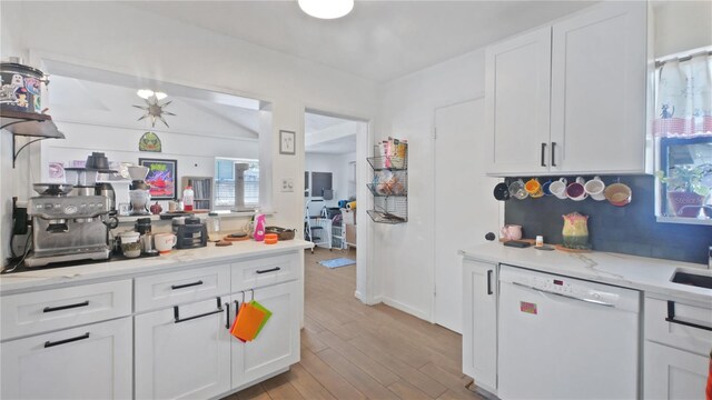 6325 9th Ave S, Gulfport, FL 33707 - kitchen featuring dishwasher, white cabinetry, light wood-style floors, and decorative backsplash