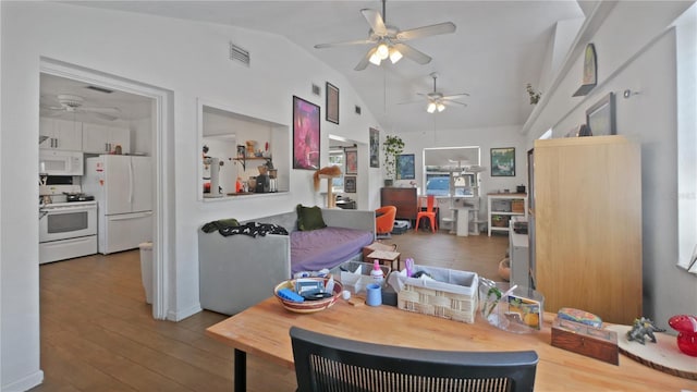 6325 9th Ave S, Gulfport, FL 33707 - dining room featuring a ceiling fan, vaulted ceiling, and wood-type flooring