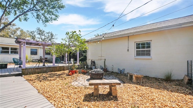 6325 9th Ave S, Gulfport, FL 33707 - view of yard with a fire pit, a wooden deck, and a pergola