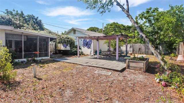 6325 9th Ave S, Gulfport, FL 33707 - fenced backyard with a sunroom, a pergola, and a wooden deck