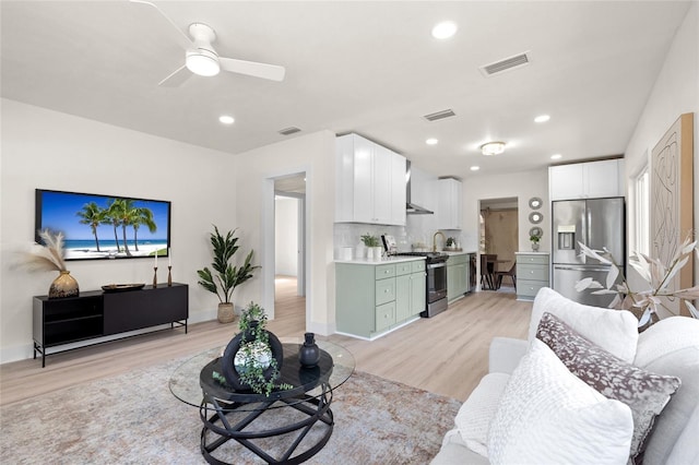 1443 Paloma Ln, Dunedin, FL 34698 - living area with light wood-style flooring, a ceiling fan, recessed lighting, and baseboards