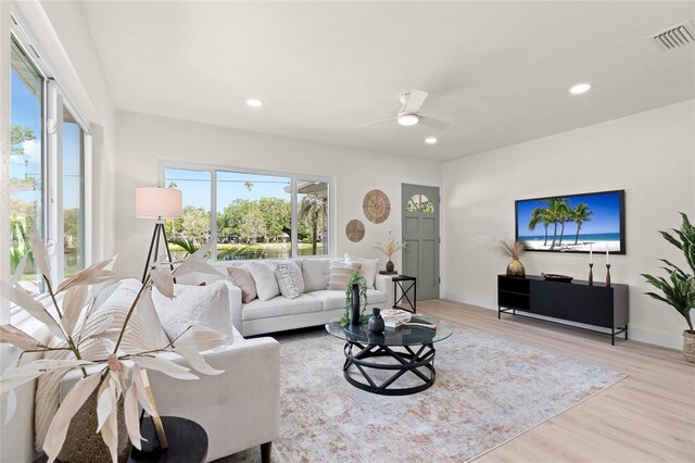 1443 Paloma Ln, Dunedin, FL 34698 - living room featuring light wood-type flooring, a ceiling fan, recessed lighting, and baseboards