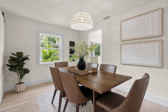 1443 Paloma Ln, Dunedin, FL 34698 - dining space with a chandelier, baseboards, and wood finished floors