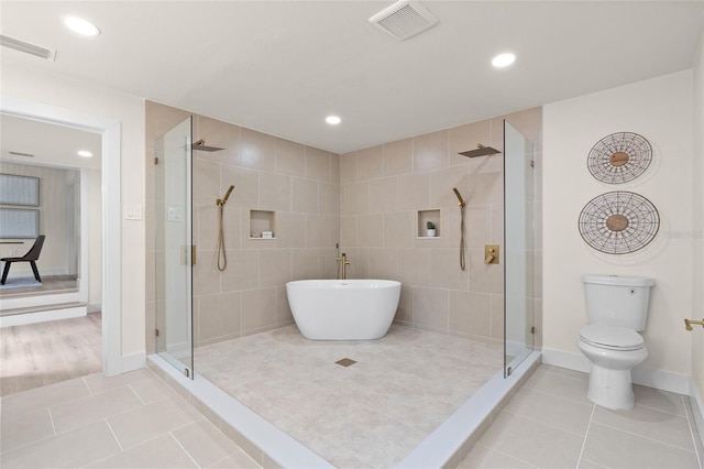 1443 Paloma Ln, Dunedin, FL 34698 - full bathroom featuring a shower stall, tile patterned floors, recessed lighting, toilet, and baseboards