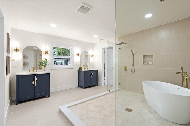 1443 Paloma Ln, Dunedin, FL 34698 - bathroom with a tile shower, two vanities, tile patterned flooring, a soaking tub, and recessed lighting