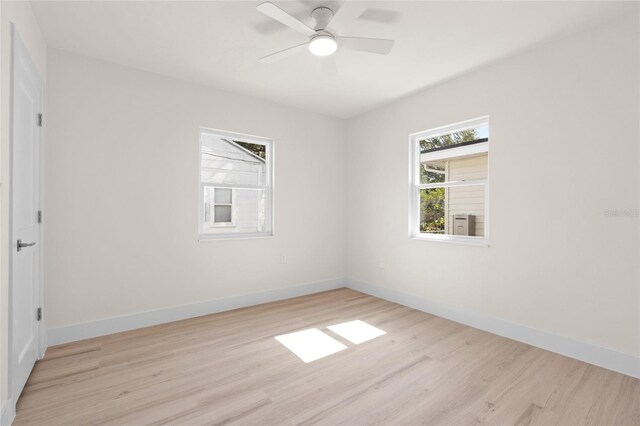 1443 Paloma Ln, Dunedin, FL 34698 - spare room with wood finished floors, baseboards, and a ceiling fan