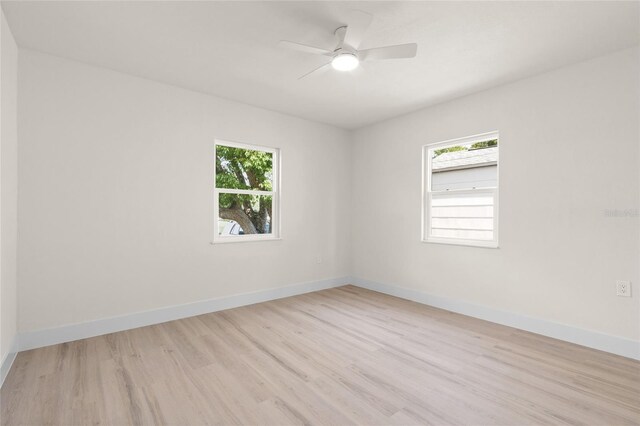 1443 Paloma Ln, Dunedin, FL 34698 - empty room with light wood-style flooring, baseboards, and ceiling fan