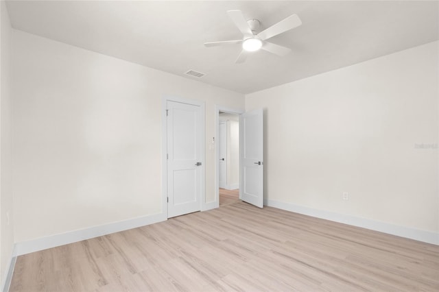1443 Paloma Ln, Dunedin, FL 34698 - spare room featuring wood finished floors, baseboards, and ceiling fan