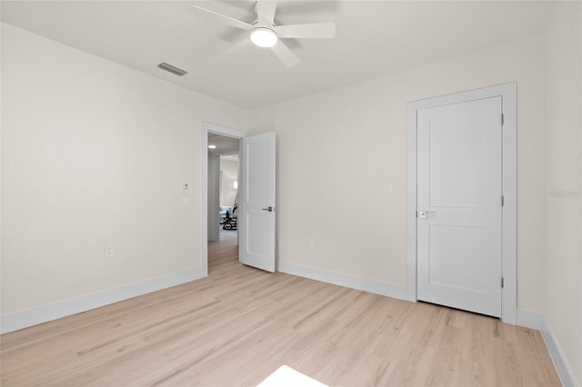 1443 Paloma Ln, Dunedin, FL 34698 - unfurnished bedroom with light wood-type flooring, baseboards, and ceiling fan