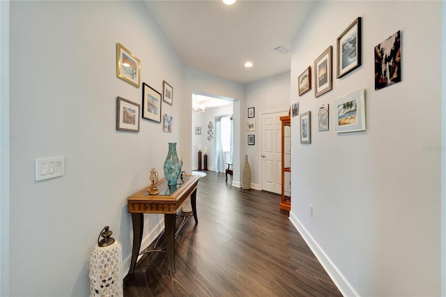 corridor with recessed lighting, baseboards, dark wood-style flooring, and visible vents