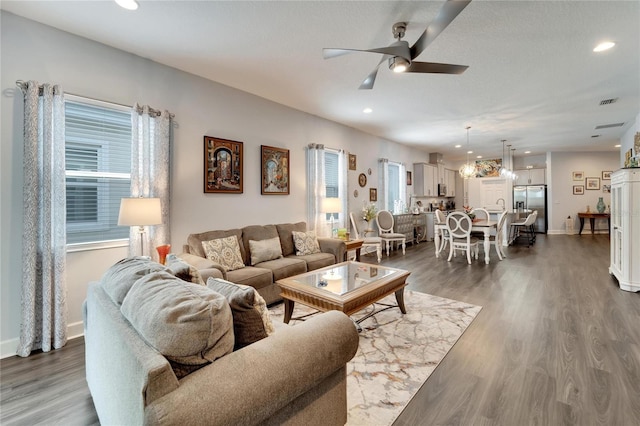living area with recessed lighting, a ceiling fan, and dark wood-style flooring