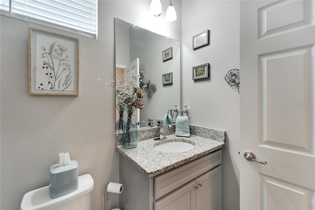 bathroom with vanity and toilet