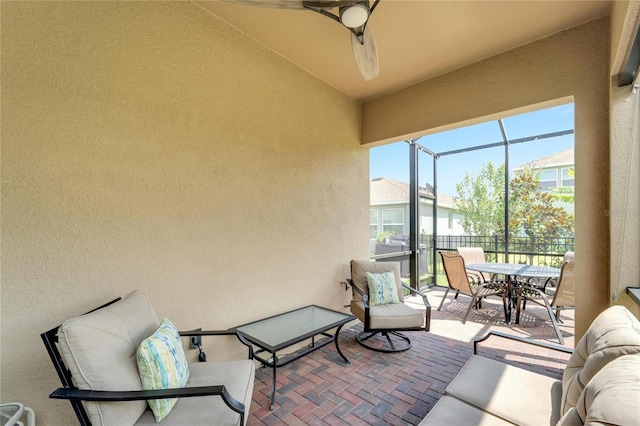 view of patio featuring outdoor dining area and a lanai