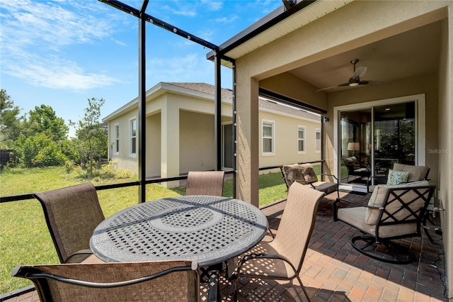 sunroom / solarium featuring ceiling fan, outdoor lounge area, and outdoor dining space