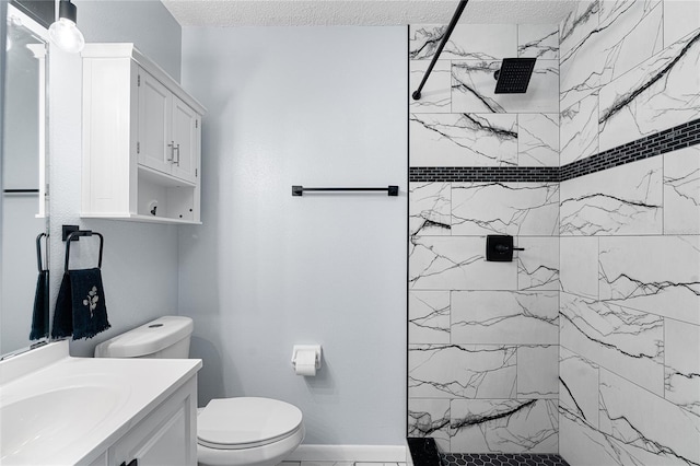 full bath featuring toilet, a textured ceiling, tiled shower, and vanity