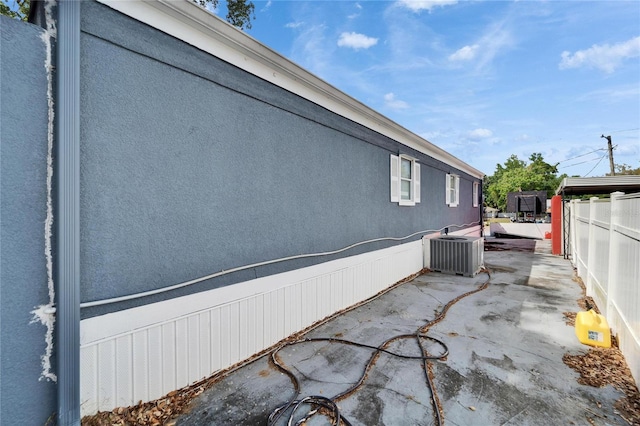 126 Ridgewood Ave, Brandon, FL 33510 - view of property exterior featuring central air condition unit, a patio, stucco siding, and fence