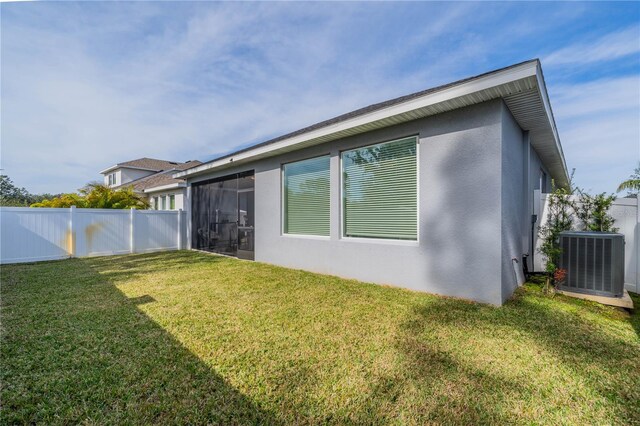 5538 Spanish Moss Cv, Bradenton, FL 34203 - rear view of property with central AC unit, stucco siding, and a sunroom