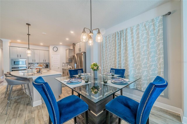 5538 Spanish Moss Cv, Bradenton, FL 34203 - dining room featuring light wood finished floors, baseboards, and recessed lighting