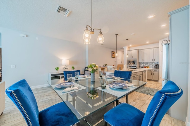 5538 Spanish Moss Cv, Bradenton, FL 34203 - dining room featuring light wood-style floors, recessed lighting, and baseboards