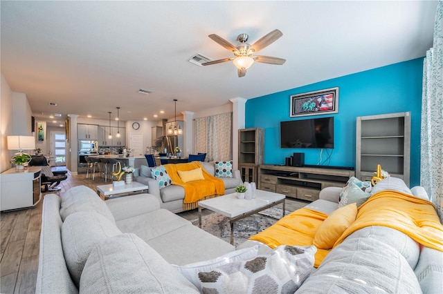 5538 Spanish Moss Cv, Bradenton, FL 34203 - living room featuring light wood-style floors, ceiling fan, an accent wall, and recessed lighting