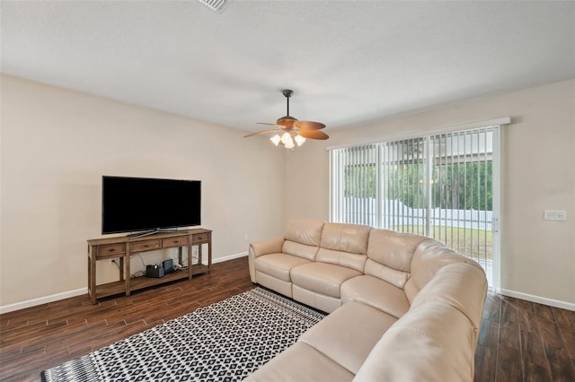 12831 White Bluff Rd, Hudson, FL 34669 - living room featuring dark wood-style floors, baseboards, and ceiling fan