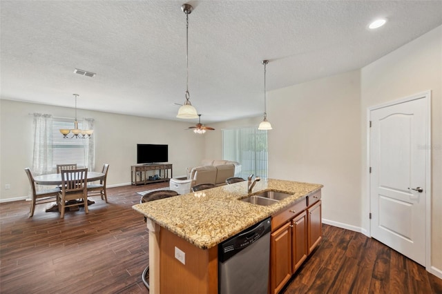 12831 White Bluff Rd, Hudson, FL 34669 - kitchen with dishwasher, a sink, plenty of natural light, a center island with sink, and a textured ceiling