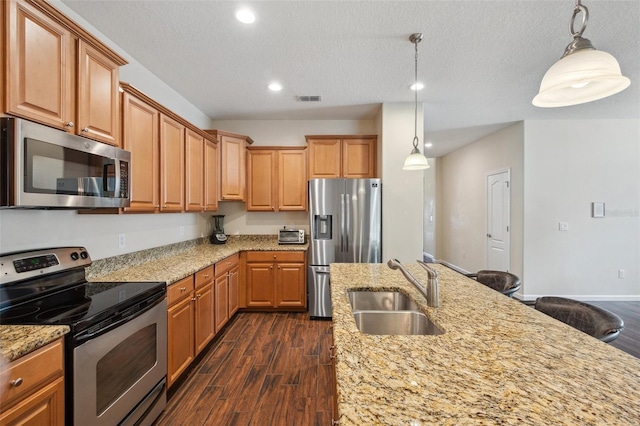 12831 White Bluff Rd, Hudson, FL 34669 - kitchen with appliances with stainless steel finishes, a sink, dark wood finished floors, recessed lighting, and light stone countertops