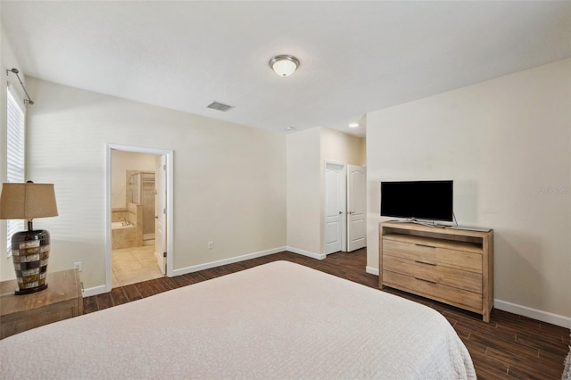 12831 White Bluff Rd, Hudson, FL 34669 - bedroom featuring dark wood-type flooring, baseboards, and connected bathroom