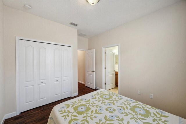 12831 White Bluff Rd, Hudson, FL 34669 - bedroom with wood finished floors, a closet, baseboards, and ensuite bath