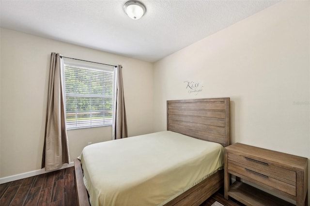 12831 White Bluff Rd, Hudson, FL 34669 - bedroom with dark wood-type flooring and baseboards