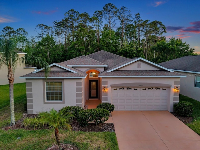 12831 White Bluff Rd, Hudson, FL 34669 - single story home with stucco siding, an attached garage, driveway, roof with shingles, and a lawn