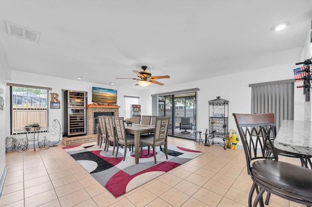 dining area with tile patterned floors, a healthy amount of sunlight, visible vents, and ceiling fan