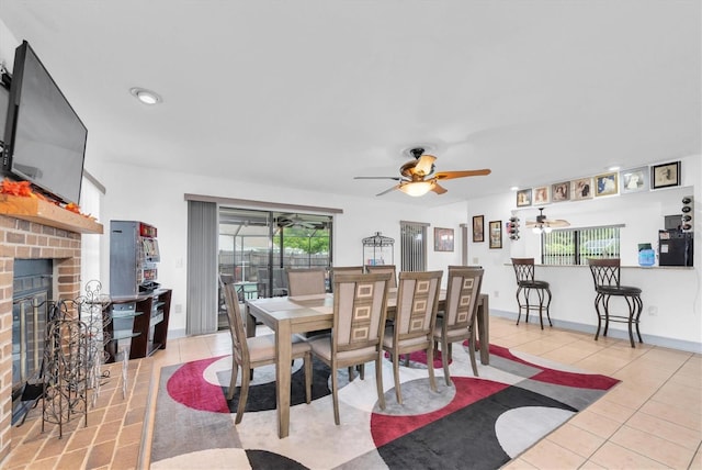 dining area with a fireplace, a ceiling fan, light tile patterned floors, and recessed lighting