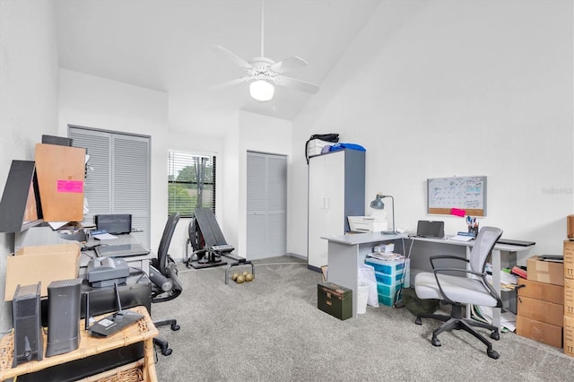 carpeted office space with vaulted ceiling and ceiling fan