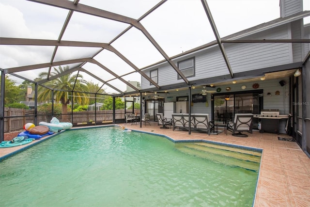view of swimming pool featuring a fenced in pool, fence, a patio, grilling area, and glass enclosure