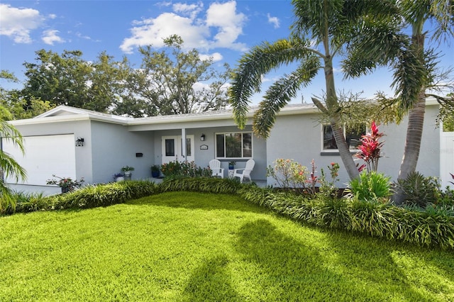 5235 42nd St S, Saint Petersburg, FL 33711 - ranch-style house featuring an attached garage, stucco siding, and a front yard