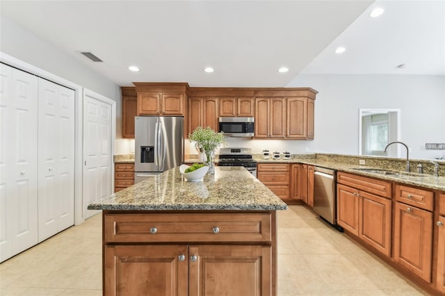 5235 42nd St S, Saint Petersburg, FL 33711 - kitchen with stainless steel appliances, a sink, light tile patterned floors, light stone countertops, and recessed lighting