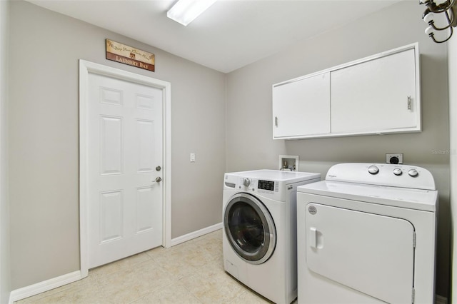 5235 42nd St S, Saint Petersburg, FL 33711 - washroom with cabinet space, separate washer and dryer, baseboards, and light tile patterned floors