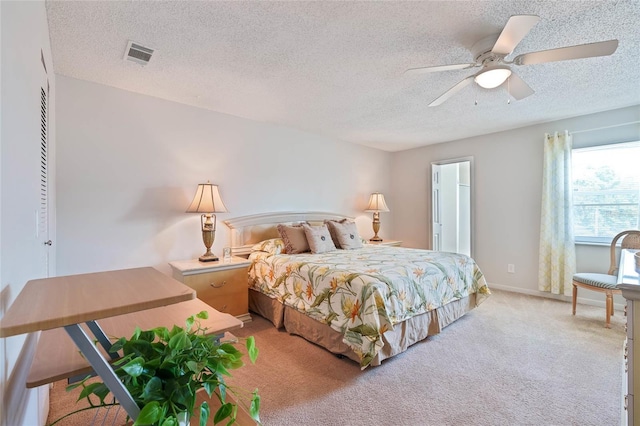 5356 81st St N Unit 26, Saint Petersburg, FL 33709 - bedroom with light colored carpet, a textured ceiling, and ceiling fan