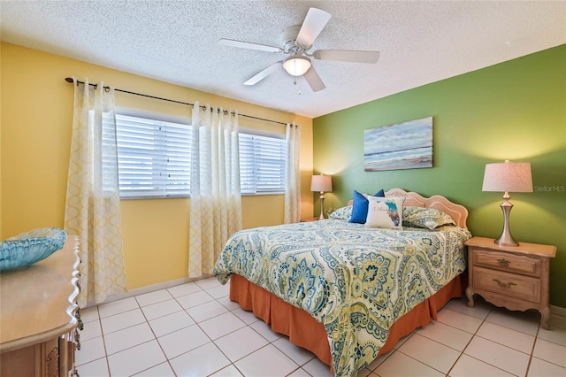 5356 81st St N Unit 26, Saint Petersburg, FL 33709 - bedroom featuring a textured ceiling, ceiling fan, and light tile patterned floors