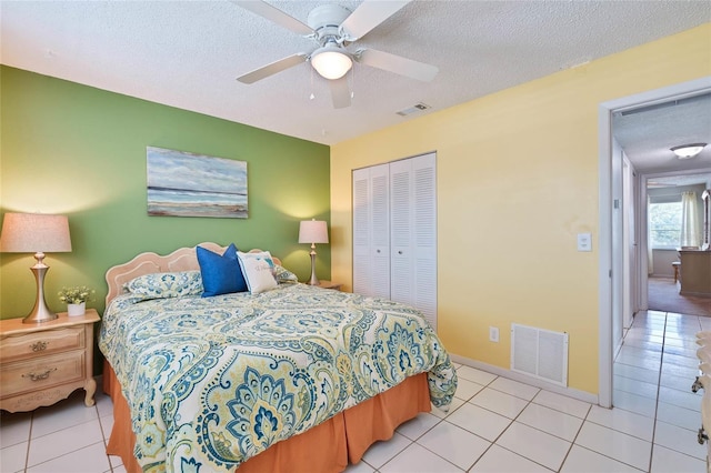 5356 81st St N Unit 26, Saint Petersburg, FL 33709 - tiled bedroom with a closet, a textured ceiling, a ceiling fan, and baseboards
