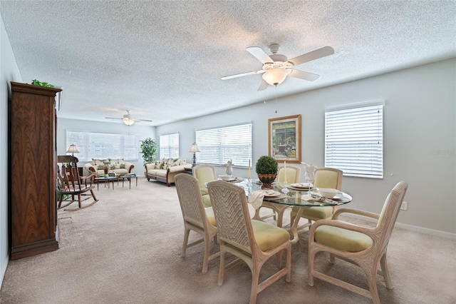 5356 81st St N Unit 26, Saint Petersburg, FL 33709 - dining area with ceiling fan, light carpet, a textured ceiling, and baseboards