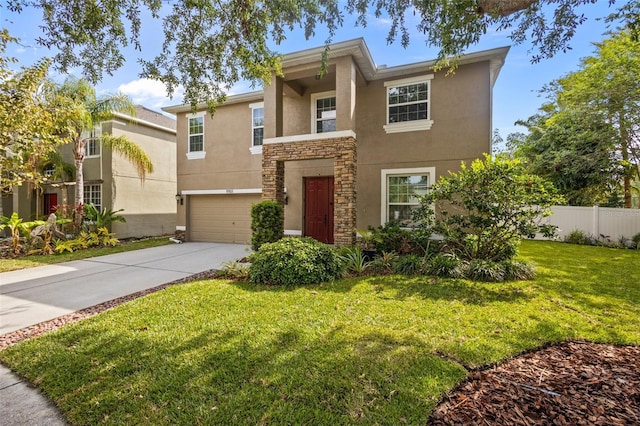 view of front of home with fence, a front yard, stucco siding, an attached garage, and driveway