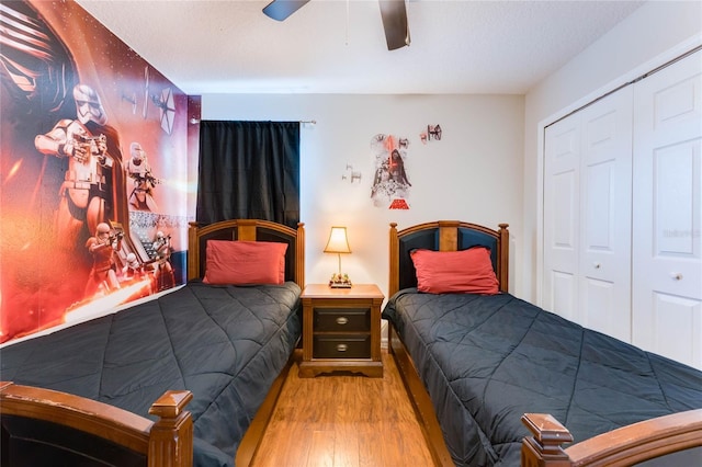 bedroom featuring a closet, a ceiling fan, and wood finished floors
