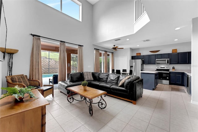 living area featuring light tile patterned floors, visible vents, and a wealth of natural light