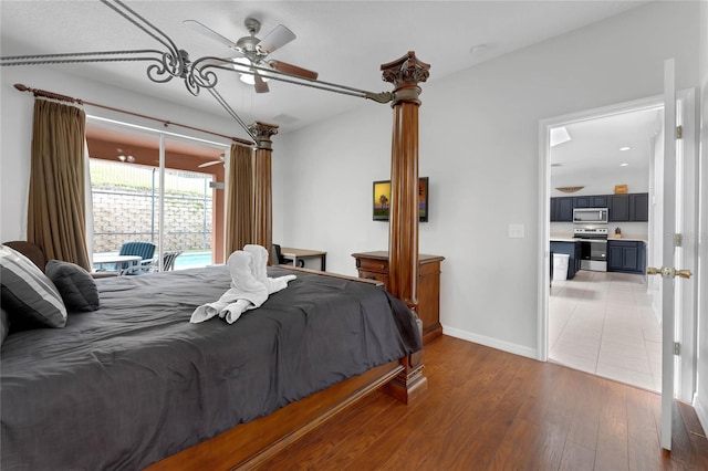 bedroom with access to outside, light wood finished floors, and baseboards