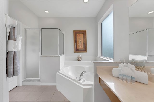bathroom featuring a healthy amount of sunlight, tile patterned flooring, a shower stall, and a bath