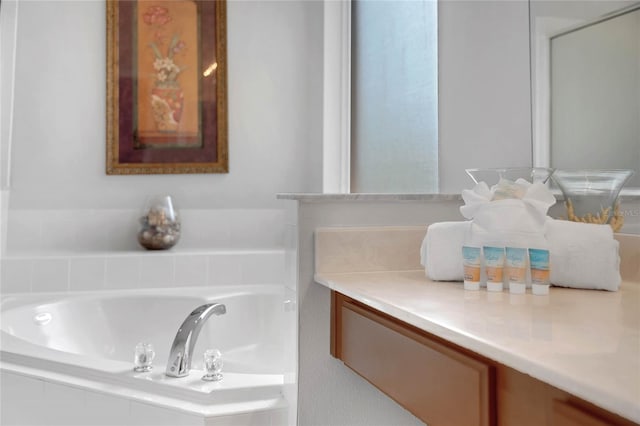 bathroom featuring a garden tub and vanity